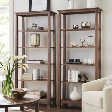 solid wood craftsmen style open bookcase made from real wood displayed with trinkets and books in a living room