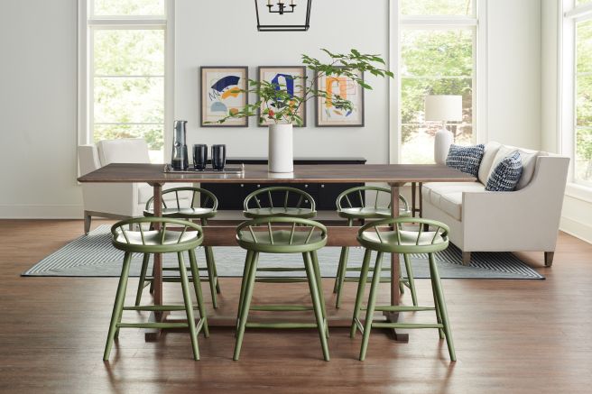 Counter height chairs paired with a modern rectangular table, offering comfort and style for casual dining and entertaining.