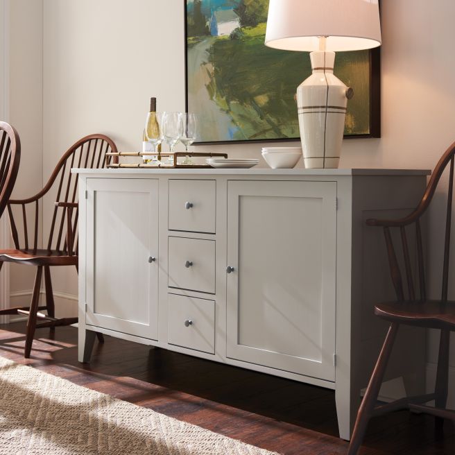 Elegant dining room featuring the Charleston Buffet in a soft gray finish with a rustic, handcrafted appeal.