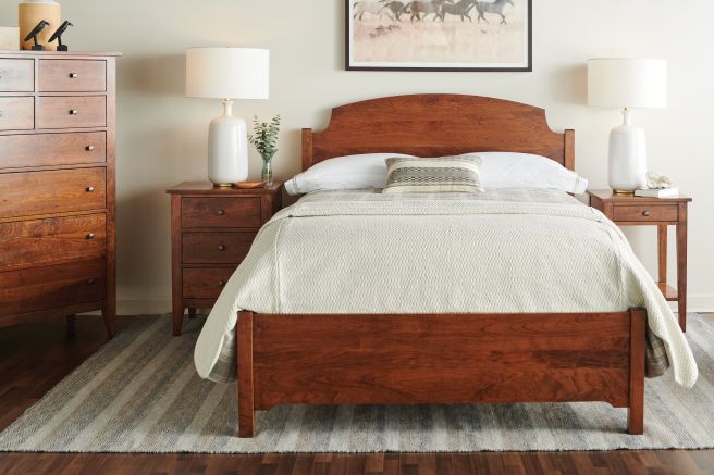 A real wood bedroom set made from sustainably sourced Appalachian cherry hardwood, featuring an heirloom-quality bed frame, nightstands, and a spacious tall dresser.
