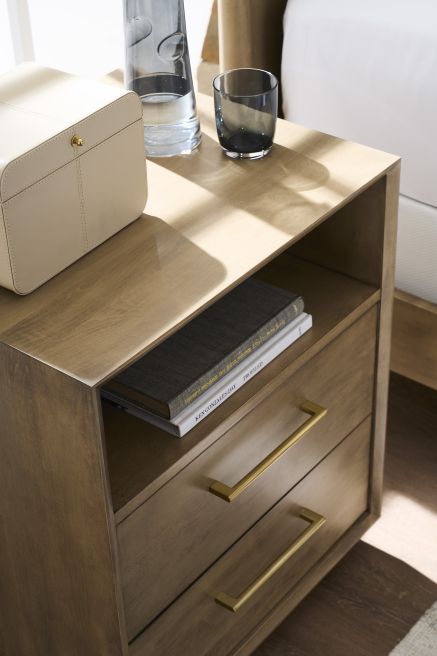 Close-up of a wooden nightstand showcasing its smooth top surface, open shelf, and two drawers with sleek hardware.