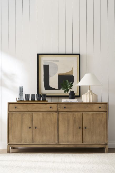Handcrafted wooden storage cabinet featuring sustainable hardwood, styled with neutral tones.