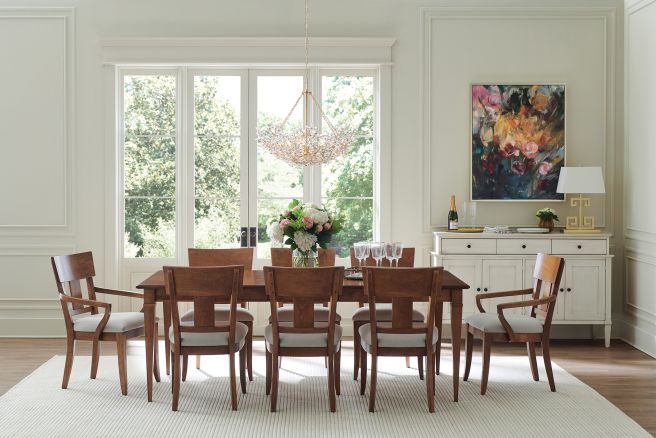 Elegant wooden dining chairs with upholstered seats surrounding a large table.