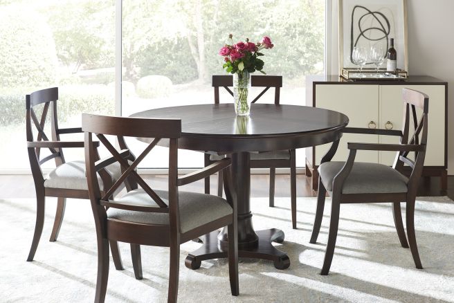 Stylish dining set featuring a round pedestal table with upholstered chairs, ideal for formal or casual gatherings.