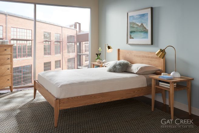 A bedroom in a city apartment featuring matching real hardwood furniture.