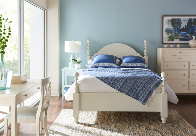 A real wood bedroom set featuring an heirloom-quality bed frame with turned details, a spacious dresser, and a coordinating nightstand.